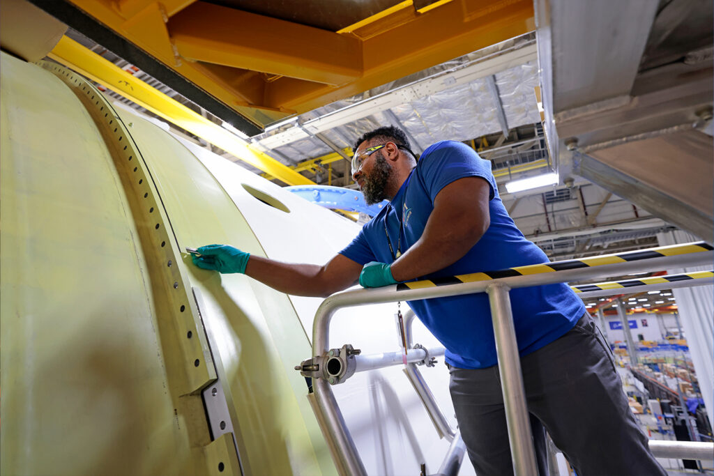 man working on aerospace and defense project - photo credit NASA/Michael DeMocker