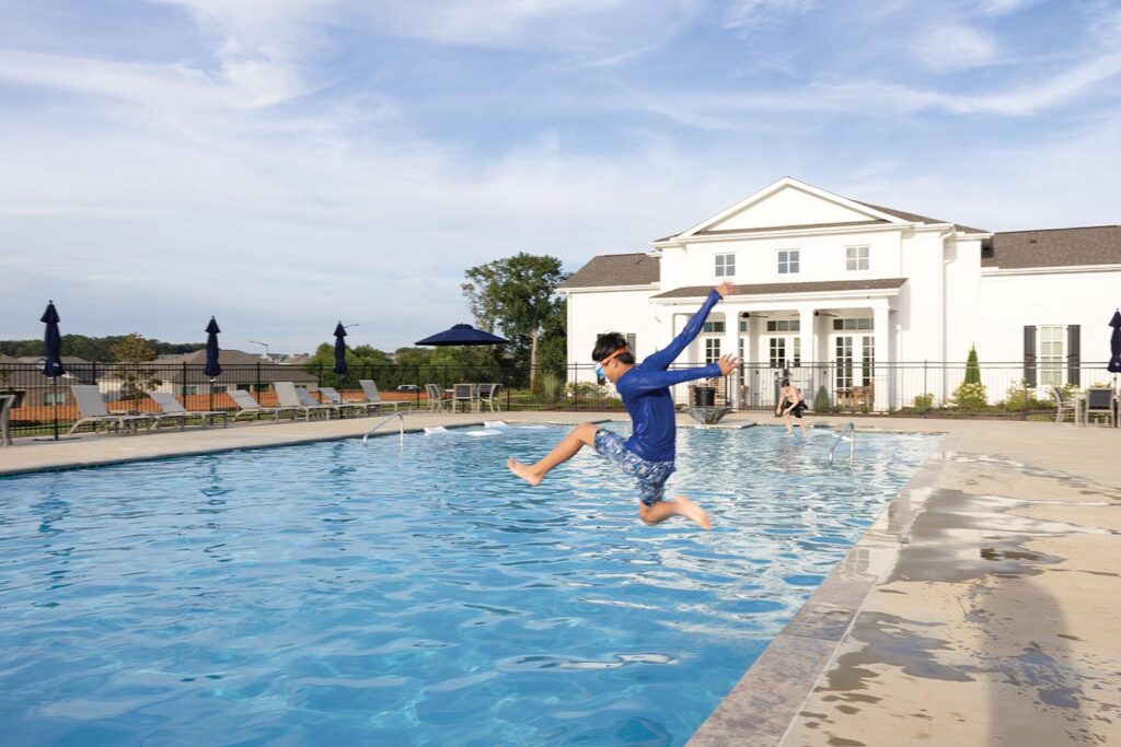 boy jumping into a pool at Clift Farm