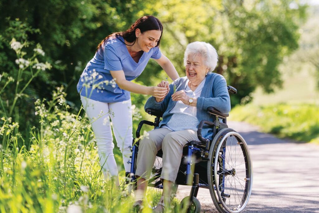 Senior woman in wheelchair with nurse