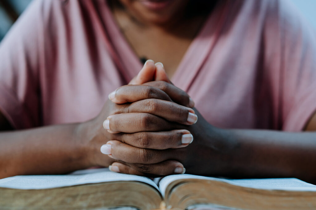 prayer hands and bible