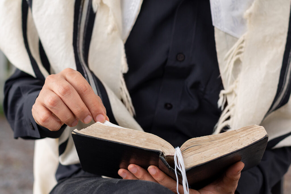 priest in robes reading religious text