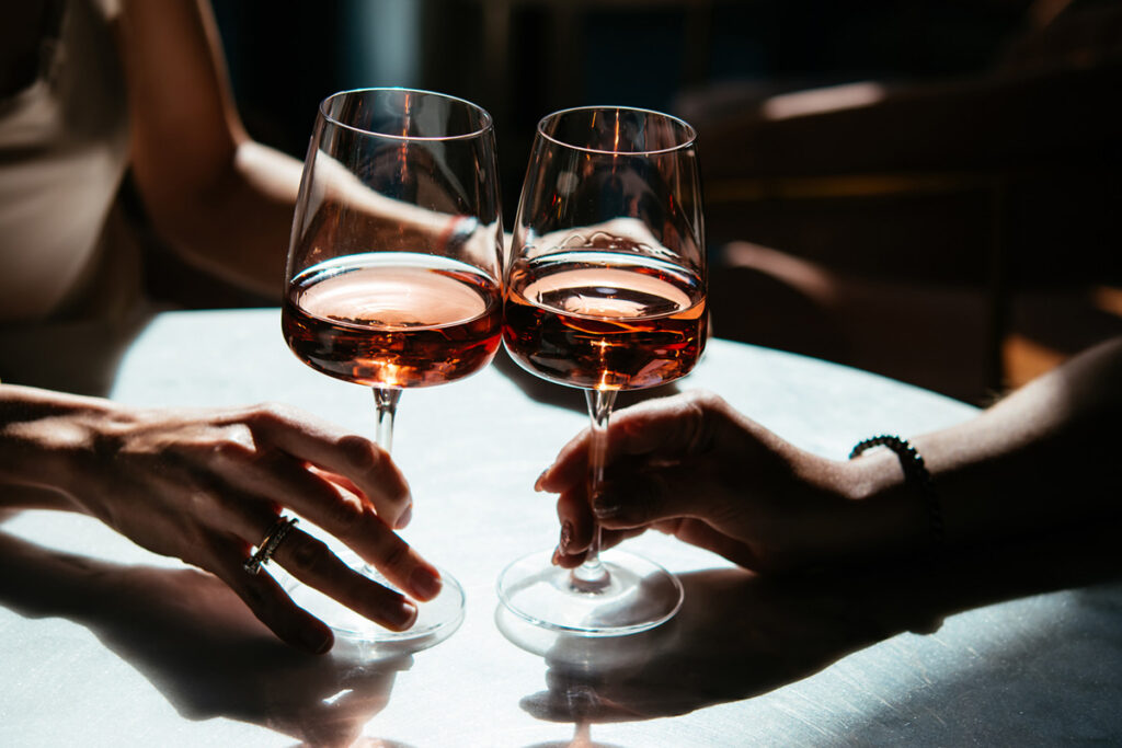 two wine glasses toasting
