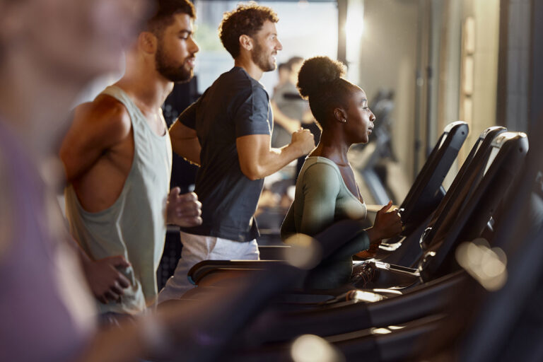 Row of people all exercising on treadmills
