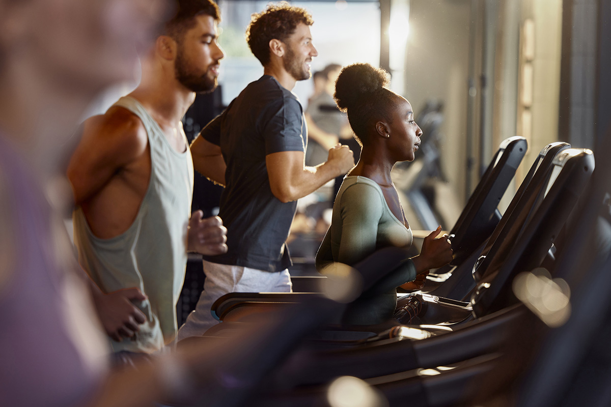 Row of people all exercising on treadmills