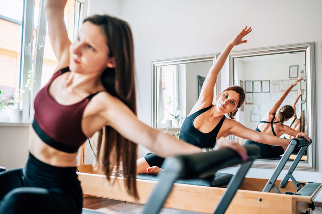 women doing pilates stretches