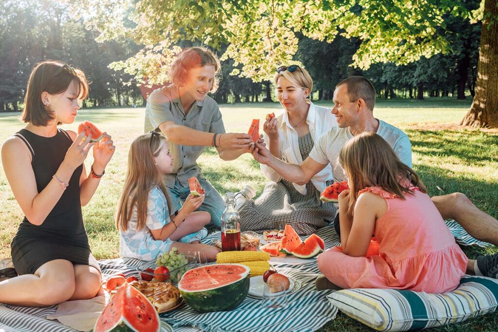 Family having a picnic eating watermelon