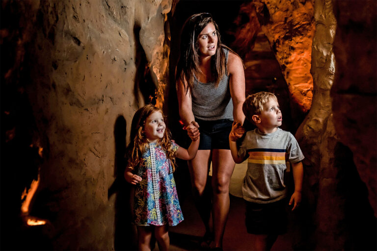 Mother and two small children exploring Cook Museum Caves